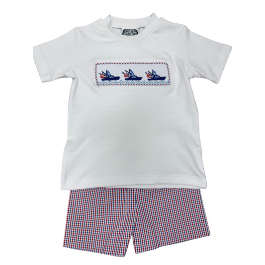 White t-shirt with embroidered boats design and red white and blue checkered shorts