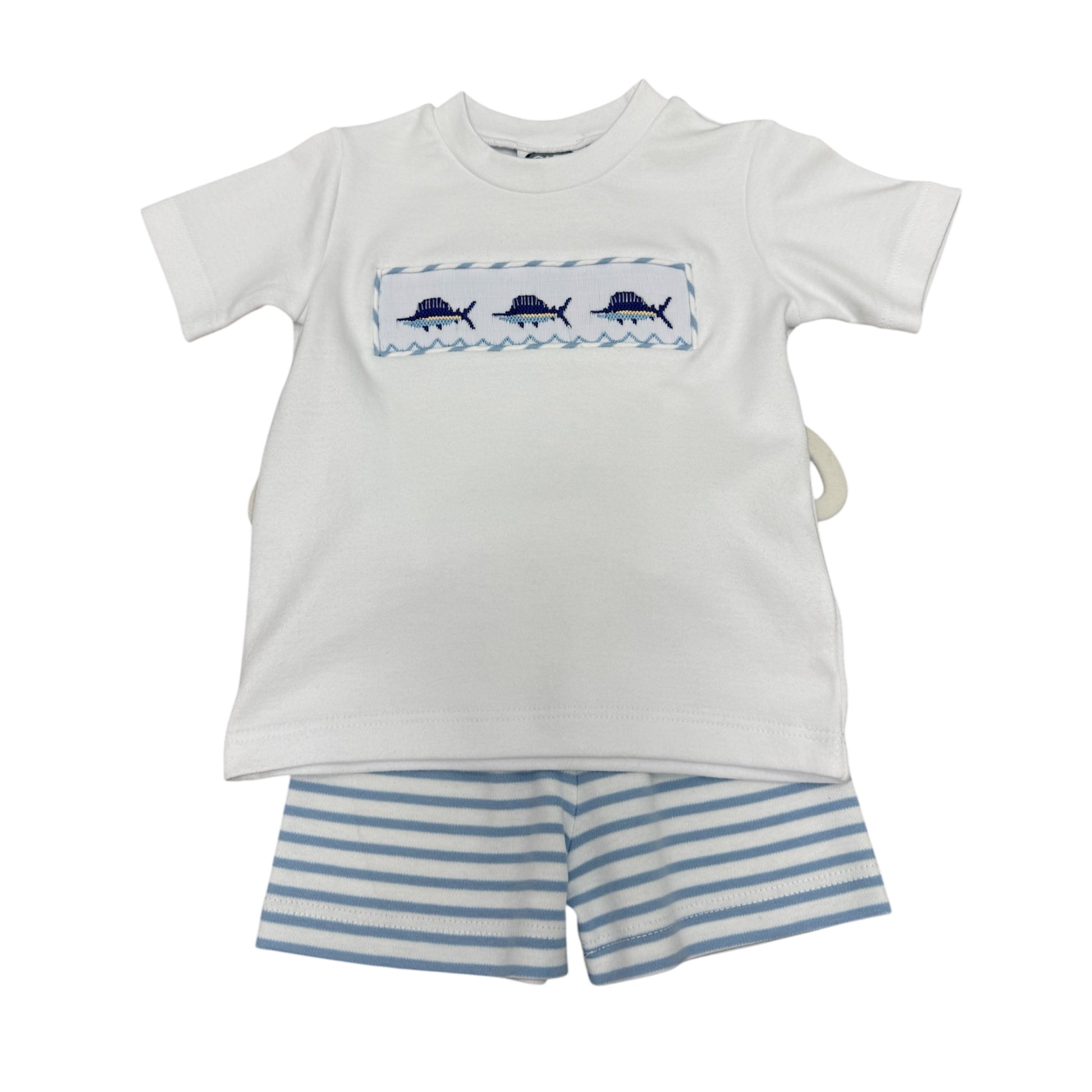 White t-shirt with smocked blue sailfish design and striped shorts background