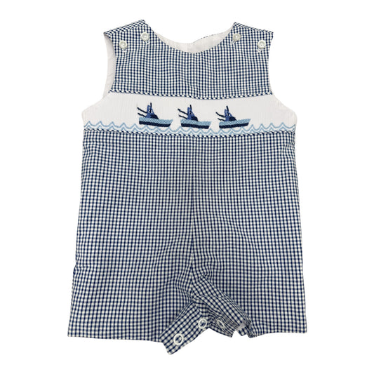 Blue and white checkered smocked romper with embroidered boats on a white background