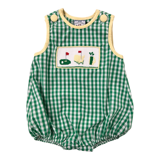 Green checkered baby romper with golf-themed patch on a white background