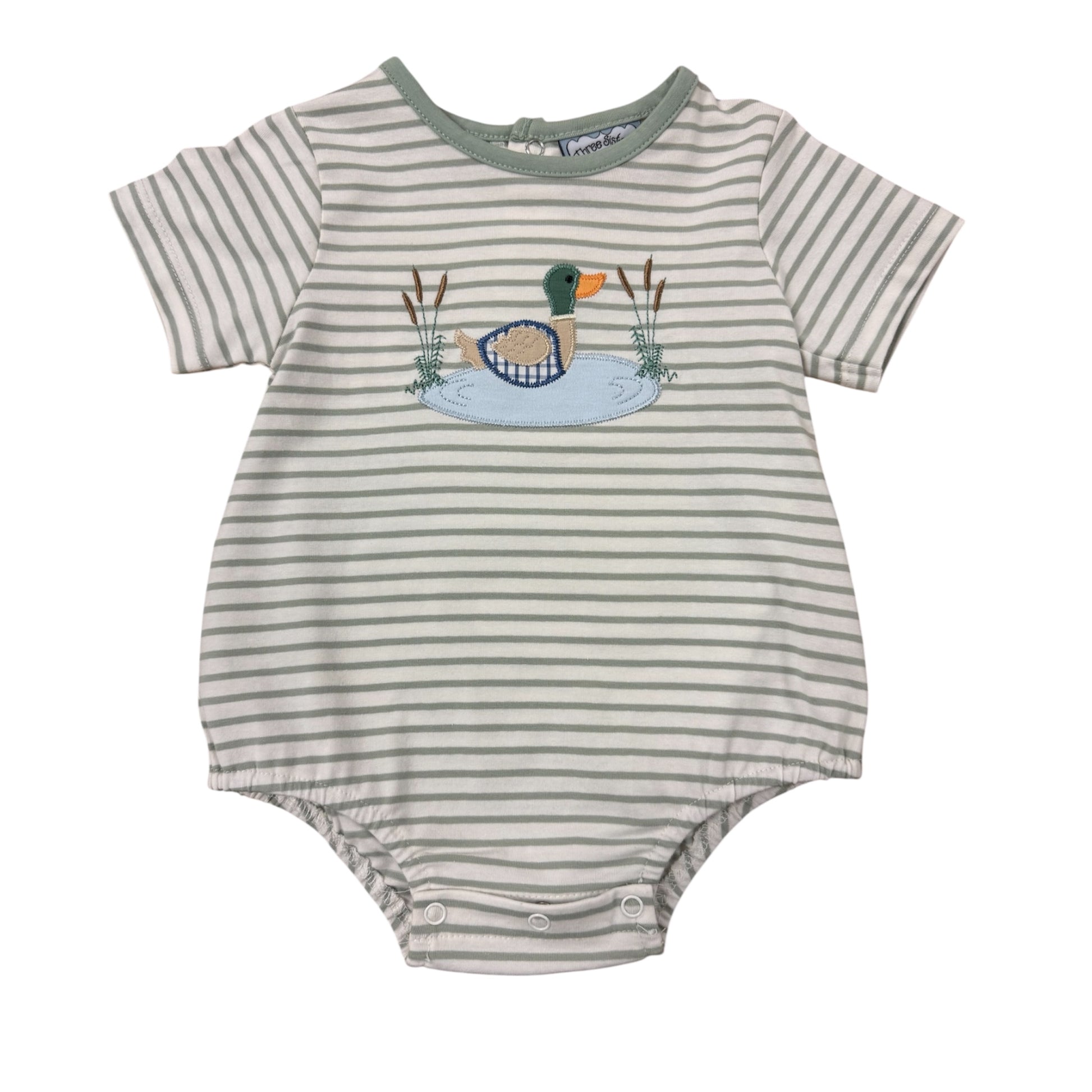 Striped baby romper with duck design on a tan background