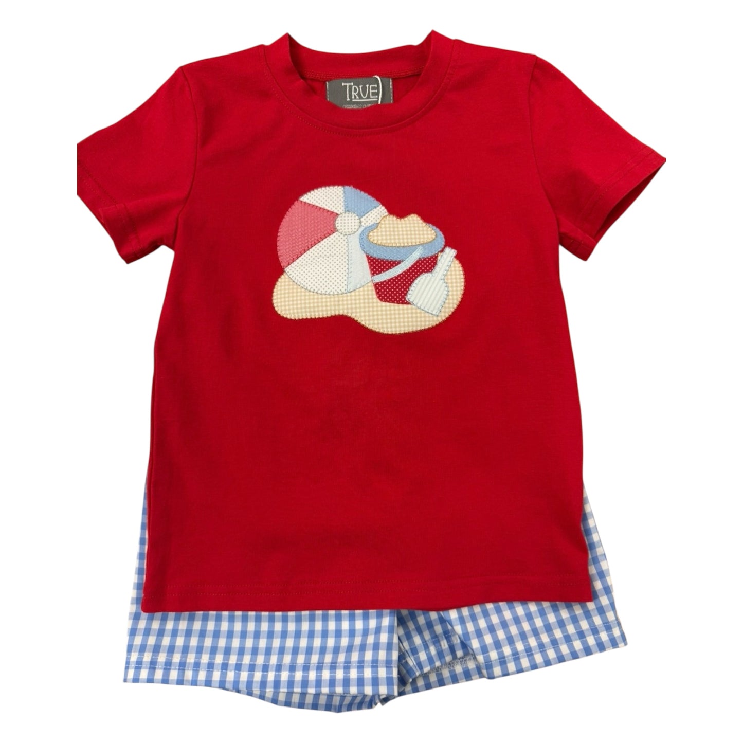 Red t-shirt with a beach ball design and blue checkered shorts 