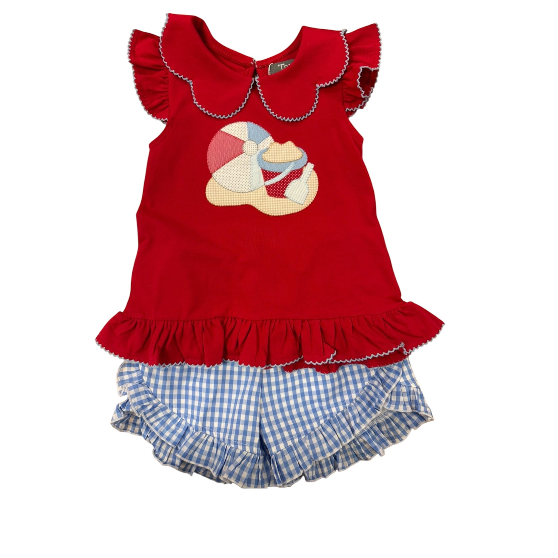Red top with ruffled collar with beach scene and blue checkered shorts 