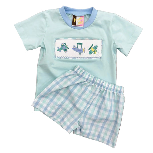 Light blue t-shirt with smocked and embroidered airplane design and coordinating plaid shorts.