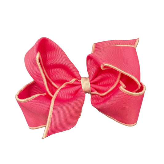 Bright pink hair bow with a white serged edge.