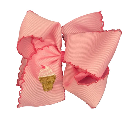Pink grosgrain hair bow with a moonstitch edge and an embroidered custard cone.
