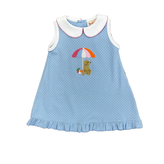 Light blue sleeveless dress with white polka dots, white trim and collar, a ruffled hem, and a puppy, beach ball and beach umbrella applique.