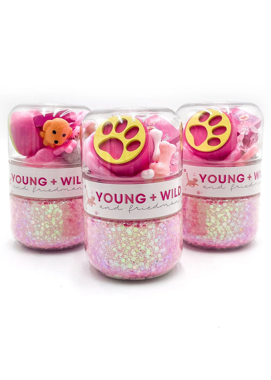 Three pink toy containers with paw designs and 'Young + Wild' branding on a white background.