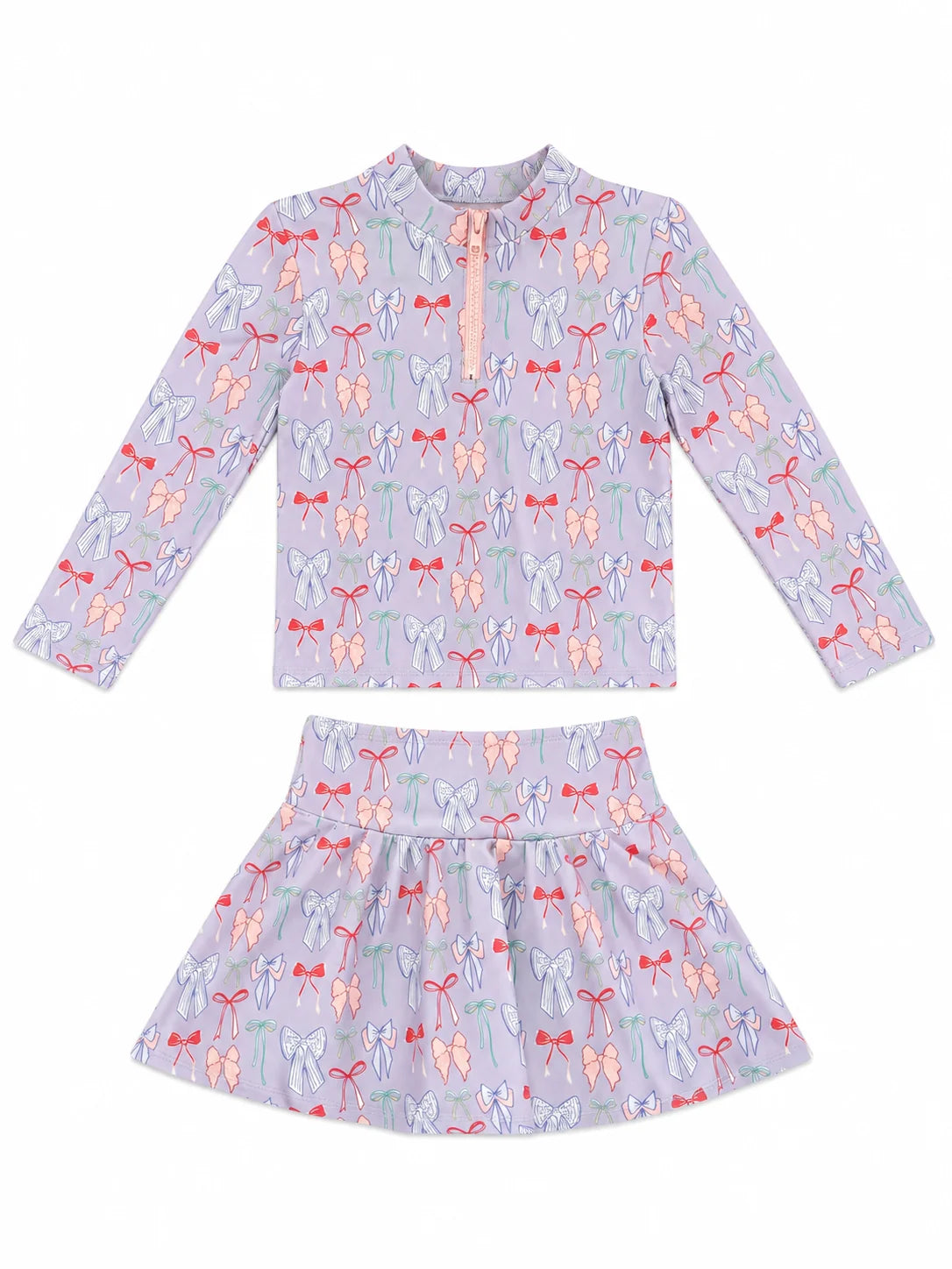 A two-piece girls' swim or lounge set featuring a long-sleeve mock-neck top and a matching flared skirt, both in a light lavender-purple color with an all-over bow  print in pink, orange, and green, displayed on a clean white background.