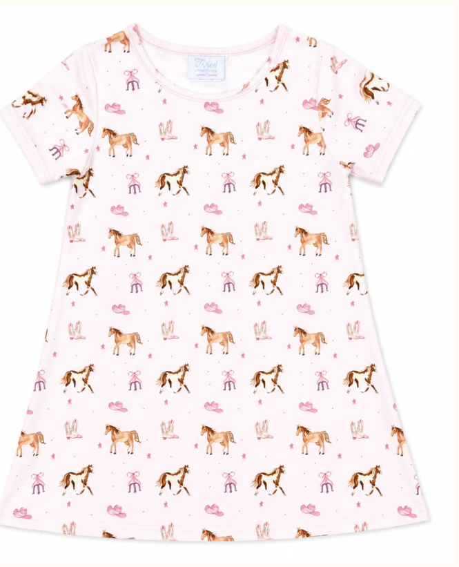 A short-sleeve play dress in light pink, featuring an all-over repeating pattern of  horses, horseshoes, cowboy boots and cowboy hats.

Details