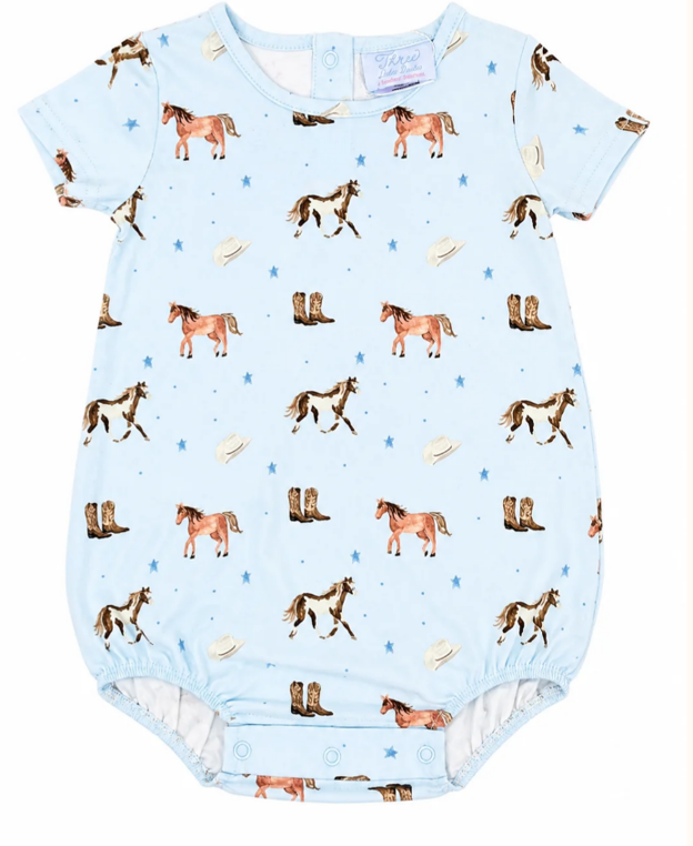 A short-sleeve bubble in light blue, featuring an all-over repeating pattern of  horses, horseshoes, cowboy boots and cowboy hats.