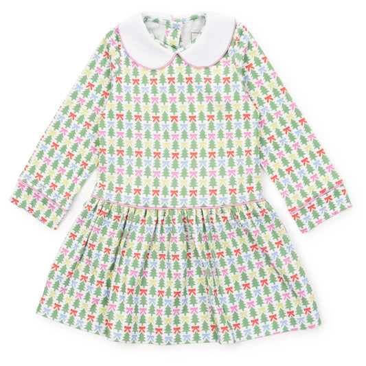 A long-sleeve baby dress with a white Peter Pan collar, featuring a green, pink, and white Christmas tree and bow pattern, laid flat on a white background.