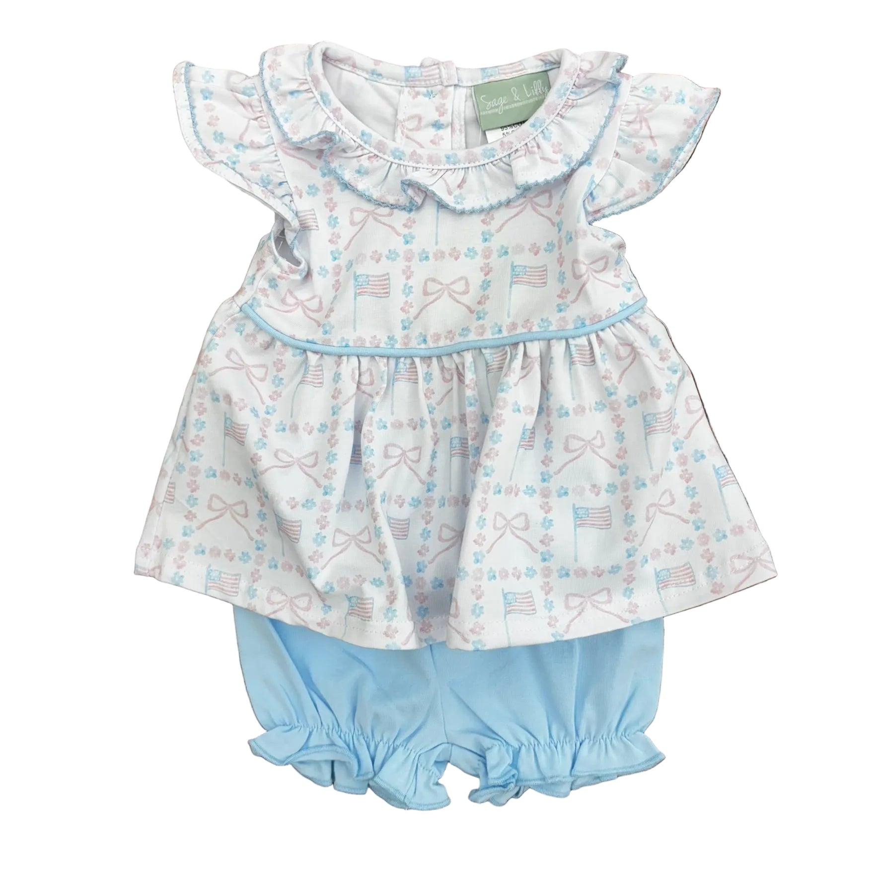 Pink and blue flag and bow design on a top with blue trim and ruffle sleeves and collar, with light blue boomers.