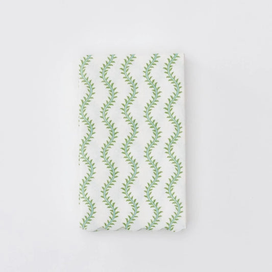 A folded white fabric item, linen napkin featuring a repeating vertical pattern of green leafy vines, shown against a plain white background.