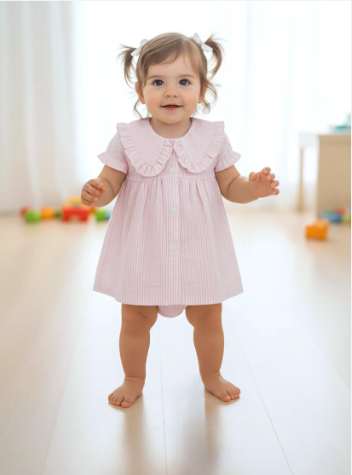Baby girl in a pink striped bloomer set with a large ruffle collar and short ruffle sleeves.