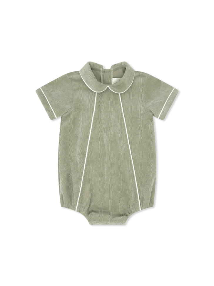 A baby short-sleeve romper in sage green cordoroy with white piping details, featuring a Peter Pan collar