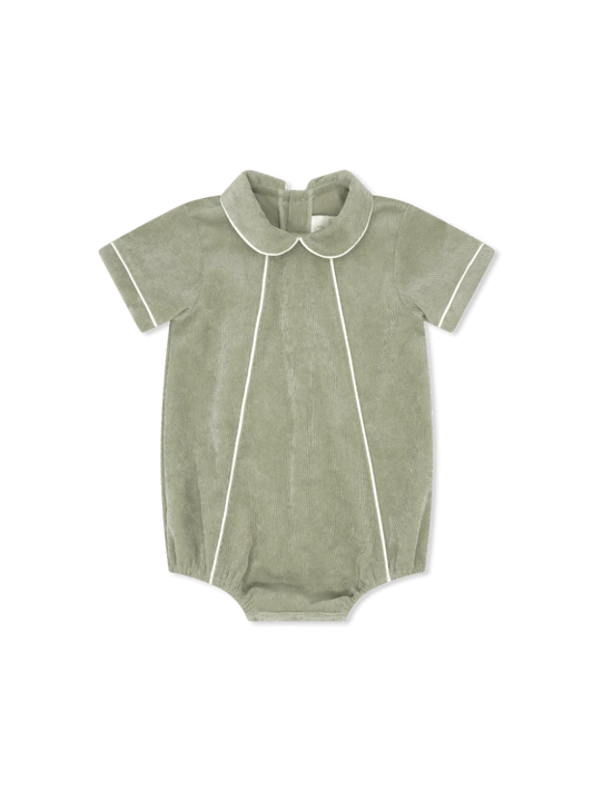 A baby short-sleeve romper in sage green cordoroy with white piping details, featuring a Peter Pan collar
