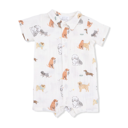Short sleeved, collard romper with dog pattern on cream background.