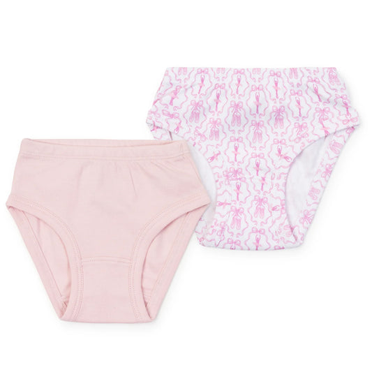 Two pairs of baby boyshorts in pink, with one solid light pink pair and one white pair featuring a pink pattern of small ballet figures and abstract shapes.