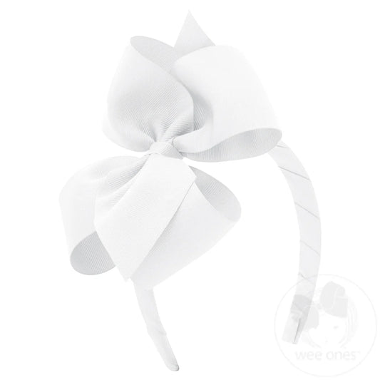 White bow on a white headband
