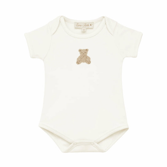 Lap shoulder ivory colored gender neutral onesie with embroidered teddy bear at the center chest.