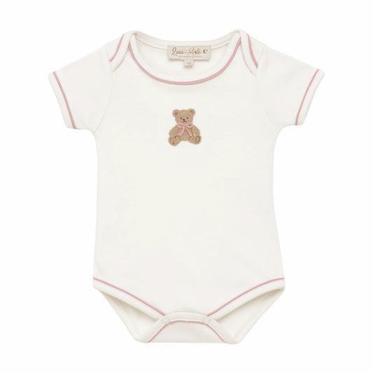 White lap shoulder bodysuit with pink trim and an embroidered bear at the center.