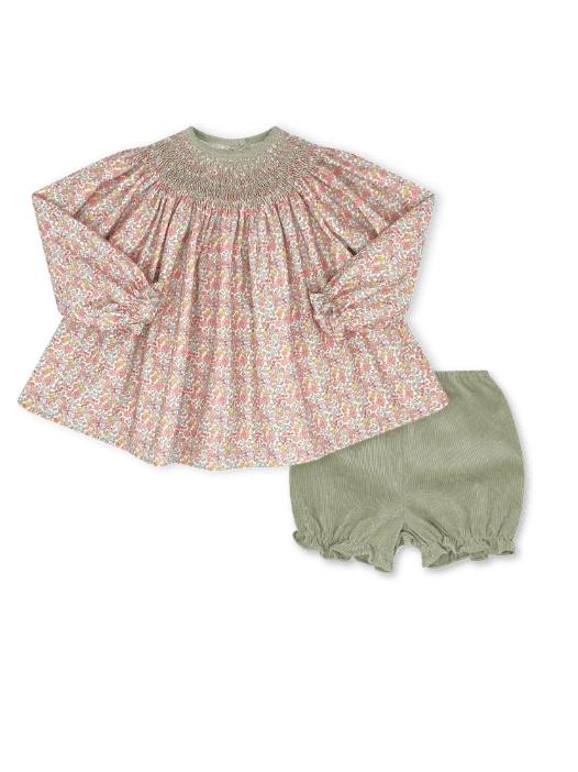 A toddler girl's two-piece outfit set featuring a long-sleeve smocked blouse with a pink, green, and white floral pattern, paired with olive green ruffled cordoroy bloomers