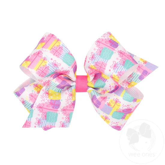 Pastel birthday gifts on a grosgrain hair bow.