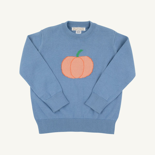 A light blue crewneck sweater featuring a stylized orange pumpkin graphic with a green stem on the chest, laid flat against a light cream background.