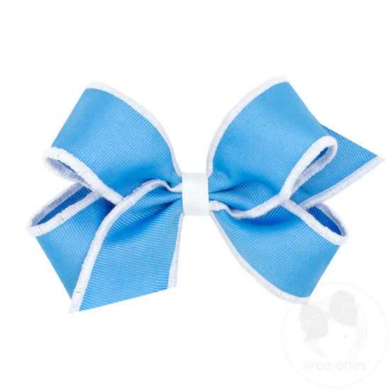 Bright blue hair bow with white serged edge.