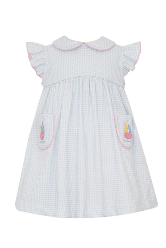Blue and white checkered dress with pink trim and sailboat designs on pocket