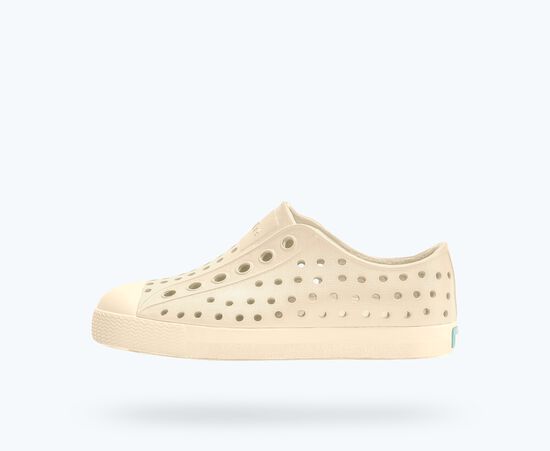 Beige shoe with holes on a white background
