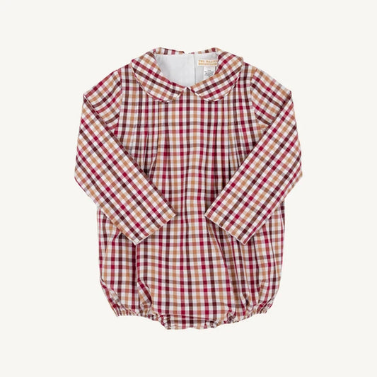 A long-sleeve baby romper in a beige, red, and tan gingham check pattern, featuring a Peter Pan collar and elasticated bubble hem, laid flat against a light cream background.