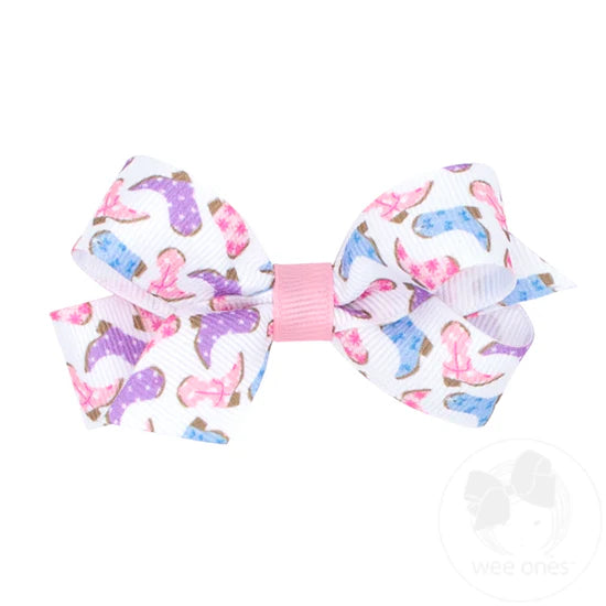 Pastel cowboy boots on a white hair bow.