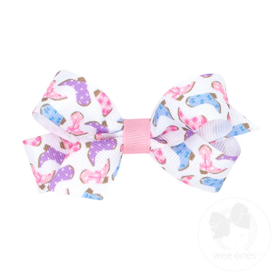Pastel cowboy boots on a white hair bow.