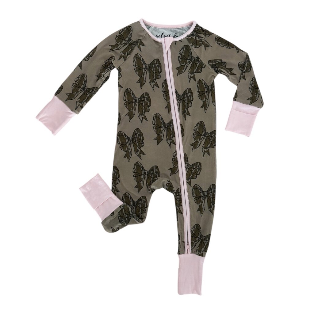 A baby long-sleeve footed one-piece sleeper in olive green with a black butterfly print and light pink cuffs and zipper trim, shown on a plain white background.