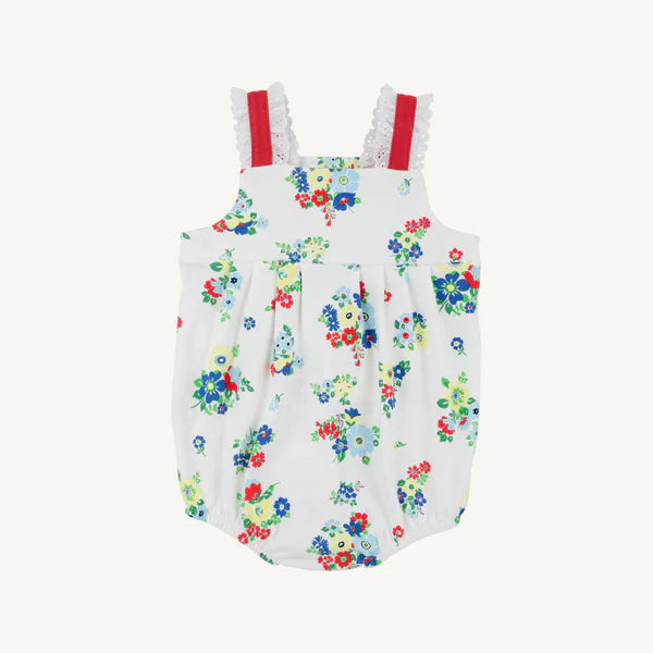 Floral-patterned baby romper with red straps on a white background