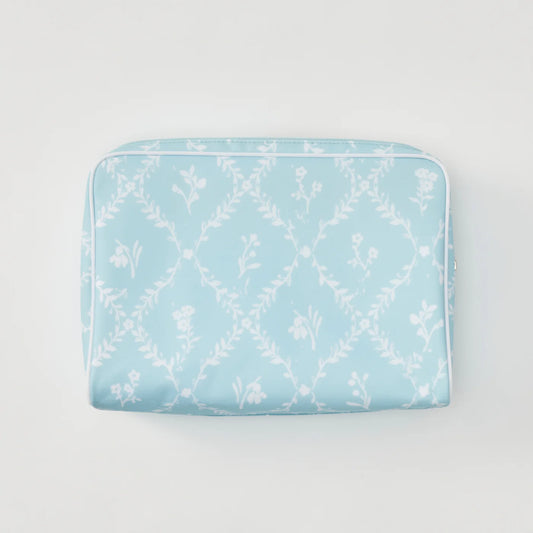A light blue zippered pouch featuring a white floral trellis pattern, photographed flat against a clean white background.