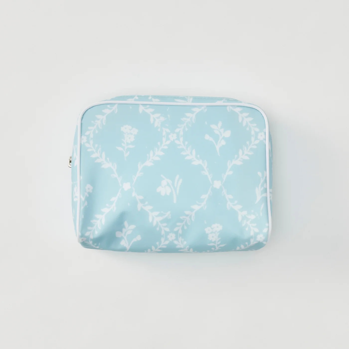 A light blue zippered pouch with a white floral and leafy trellis pattern, photographed flat against a clean white background.