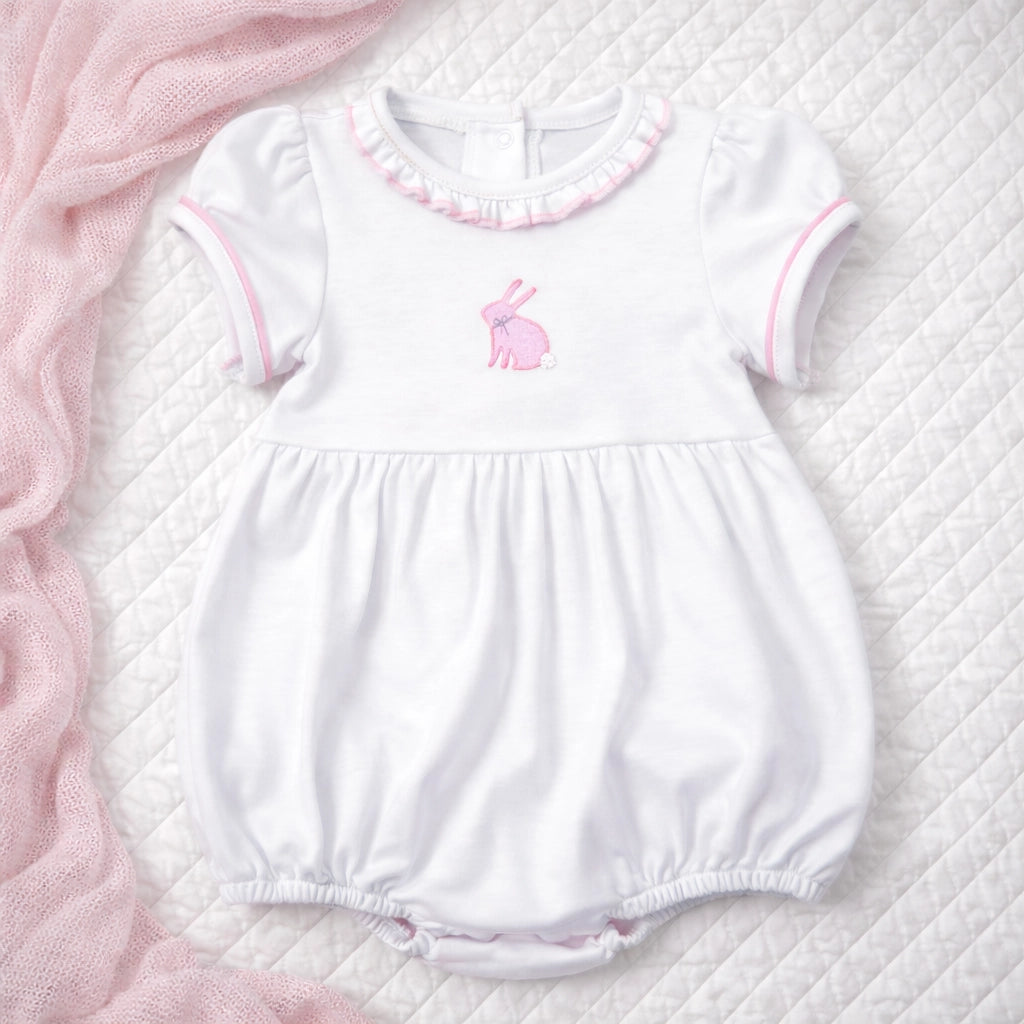 White baby romper with pink trim and bunny design 