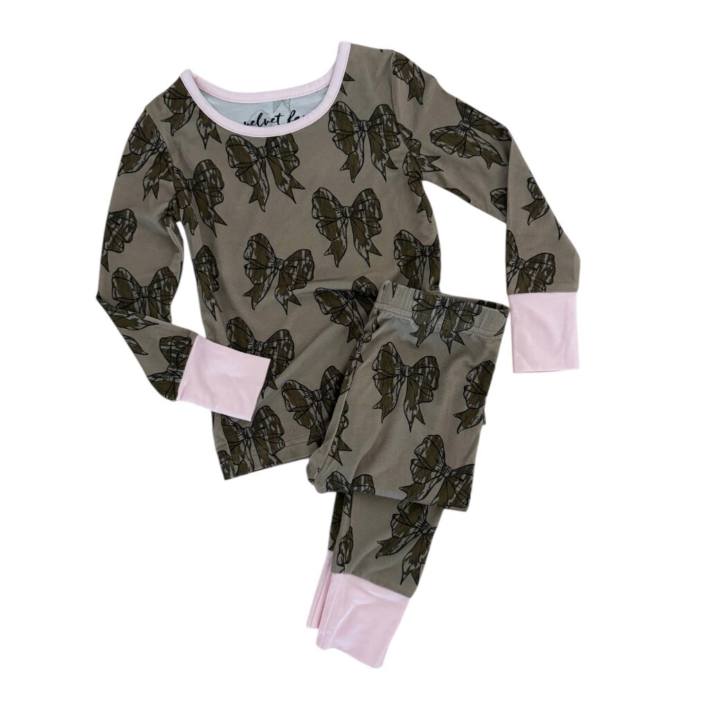 A two-piece pajama set for a child, featuring a long-sleeve top and matching pants in olive green with a black butterfly print and light pink cuffs and collar trim, laid flat on a white background.