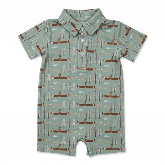 A baby short-sleeve romper in sage green with an all-over print of brown logs, pine trees, and campers, featuring a buttoned collar and snap closure.