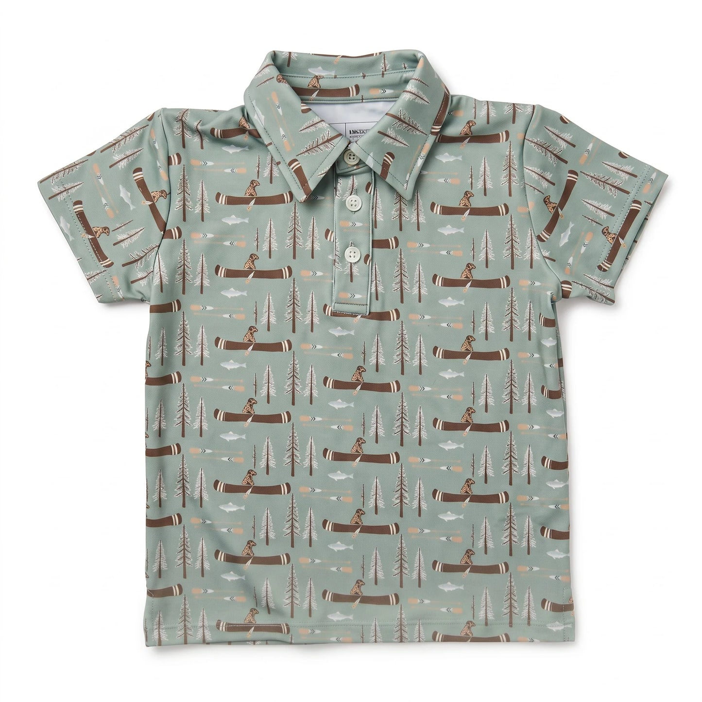 A short-sleeve polo shirt for kids, featuring a sage green background with an all-over repeating pattern of brown logs, pine trees, and figures canoeing on the water.