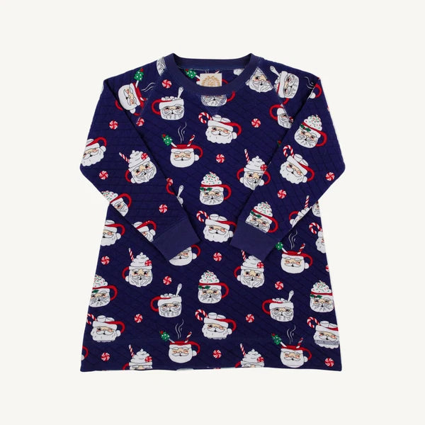 A navy blue long-sleeve quilted dress  with an all-over Christmas-themed print of mugs filled with hot cocoa, candy canes, and Santa hats, displayed flat against a light off-white background.