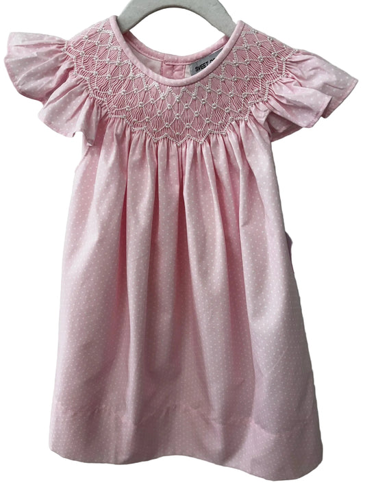 Pink polka dot dress with ruffle sleeves and pearl embellished smocking.
