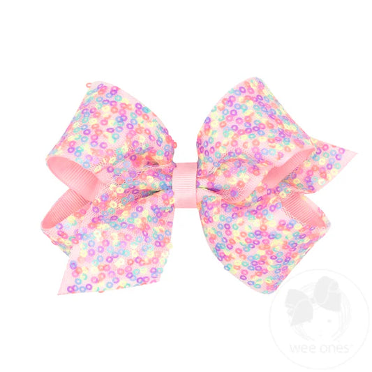 Multicolor confetti overlay over a light pink grosgrain bow.