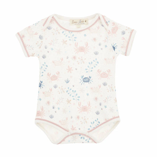 Baby bodysuit with pink crab and shell pattern on a white background
