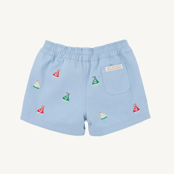 Light blue shorts with embroidered sailboat designs 