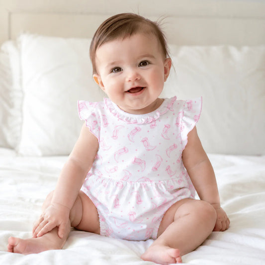 Ruffle trimmed bubble with a pink cowboy boot pattern.