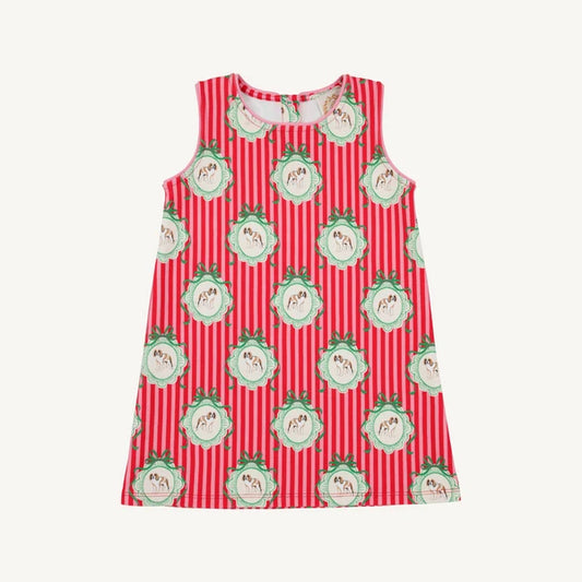 A sleeveless children's dress with a red and white vertical stripe pattern, decorated with repeating green and white dog medallion motifs, shown flat against a light off-white background.